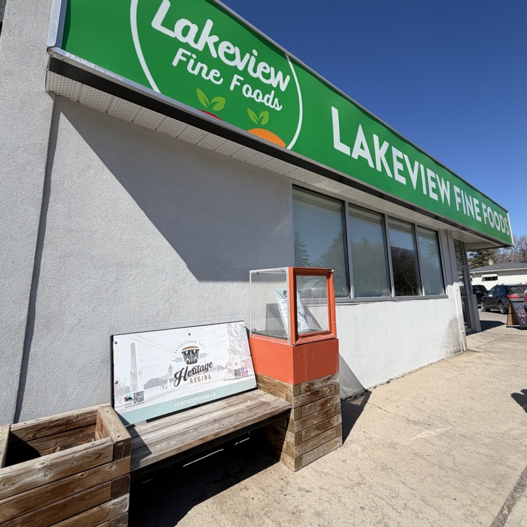 A view of the Lakeview Heritage Regina Story Bench outside Lakeview Fine Foods on Hill Ave.